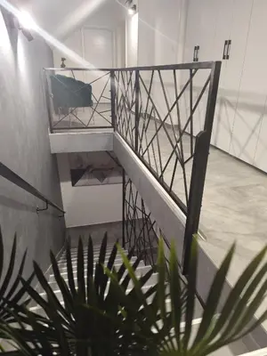 a staircase in a room with a plant at Nomad apartments in Belgrade