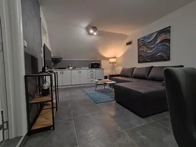 a living room with a couch and a kitchen at Nomad apartments in Belgrade