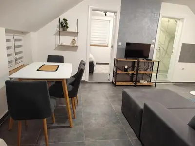 a living room with a table and a couch at Nomad apartments in Belgrade