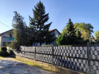 a white picket fence in front of a house at Nomad apartments in Belgrade