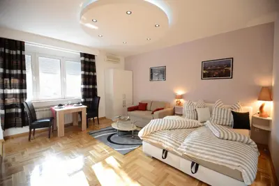a living room with a bed and a couch at Skadarlija Square in Belgrade