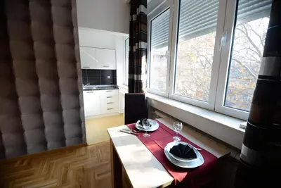 a kitchen with a table with a plate of food on it at Skadarlija Square in Belgrade