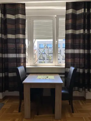 a table and two chairs in front of a window at Skadarlija Square in Belgrade