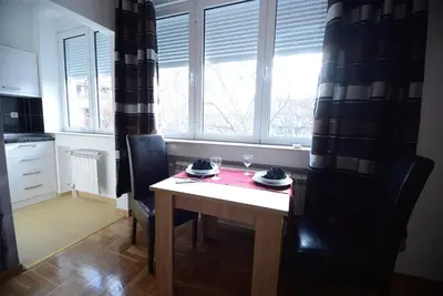 a kitchen with a table and chairs and a window at Skadarlija Square in Belgrade