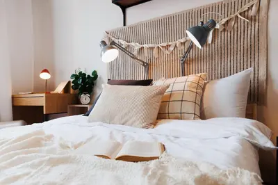 a bedroom with a bed with an open book on it at Sweet Nest 100m2 with Terrace Old Town Renovated in Belgrade