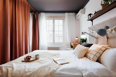 a bedroom with a white bed with a plate of food on it at Sweet Nest 100m2 with Terrace Old Town Renovated in Belgrade