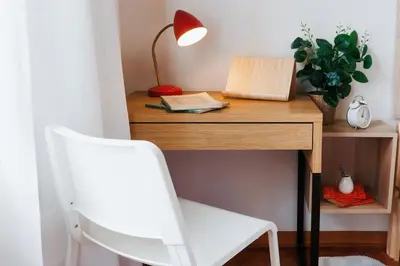 a desk with a white chair and a lamp on it at Sweet Nest 100m2 with Terrace Old Town Renovated in Belgrade