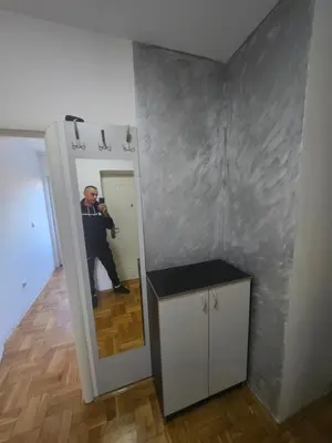 a man taking a picture of himself in a mirror at Apartman daba 1 in Belgrade