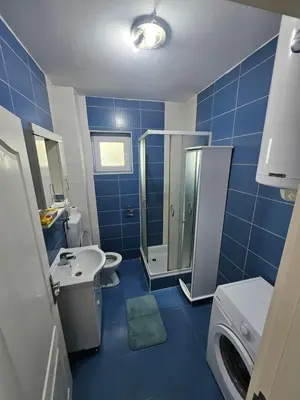 a blue bathroom with a sink and a shower at Apartman daba 1 in Belgrade