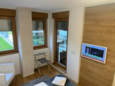 a living room with a tv on a wall at A Blok A12 in Belgrade