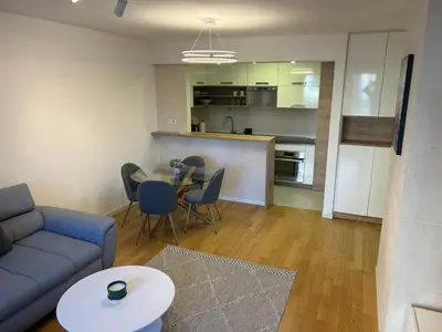 a living room with a couch and a table and a kitchen at A Blok A12 in Belgrade
