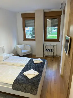 a bedroom with a bed with two towels on it at A Blok A12 in Belgrade