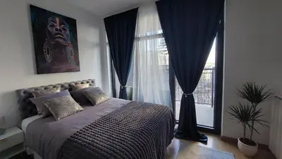 a bedroom with a bed in front of a window at BW Vista studio M&M - free parking in Belgrade