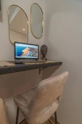 a laptop computer sitting on a desk with a chair at BW Vista studio M&M - free parking in Belgrade