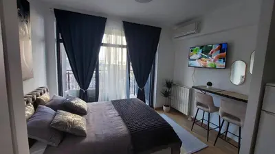 a bedroom with a bed and a large window at BW Vista studio M&M - free parking in Belgrade
