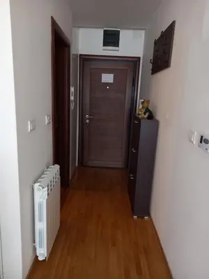 a hallway with a door and a wooden floor at Simon in Karaburma