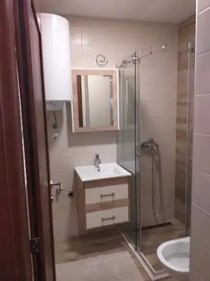 a bathroom with a sink and a shower at Simon in Karaburma