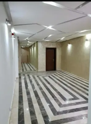 an empty room with a striped floor in a building at Simon in Karaburma
