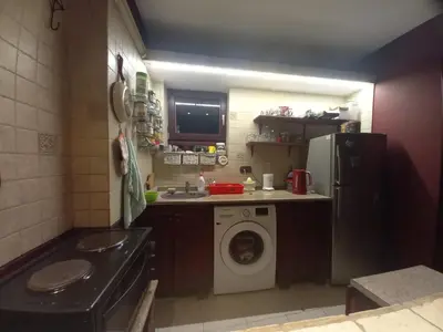 a small kitchen with a washing machine and a refrigerator at Mirara in Belgrade