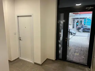 a door leading to a street with a sidewalk at Ada Smart Apartment in Belgrade