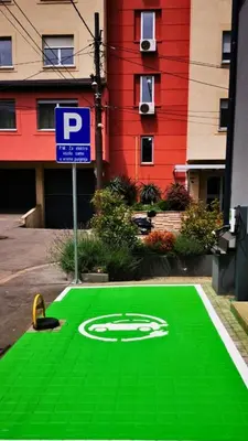 a green floor with a parking sign on it at Ada Smart Apartment in Belgrade