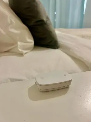 a white cell phone sitting on top of a bed at Ada Smart Apartment in Belgrade