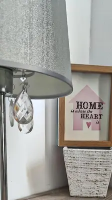 a lamp in a room with a picture and a sign at Open-space Apartment in the city center in Belgrade