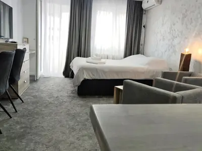 a hotel room with two beds and a couch at Open-space Apartment in the city center in Belgrade