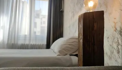 a bedroom with a bed with a light on top at Open-space Apartment in the city center in Belgrade