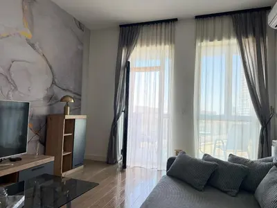 a living room with a couch and a large window at ASTRA LUX - Galerija Beograd na vodi - Belgrade Waterfront in Belgrade