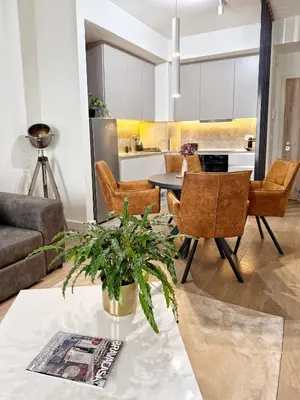 a living room with a table and chairs at ASTRA LUX - Galerija Beograd na vodi - Belgrade Waterfront in Belgrade