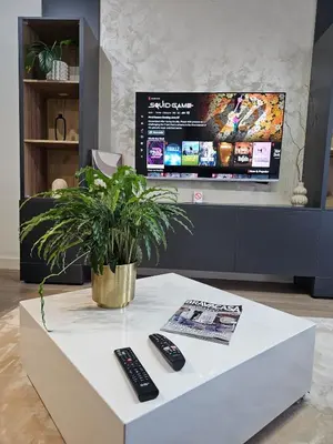 a white coffee table with two remote controls on it at ASTRA LUX - Galerija Beograd na vodi - Belgrade Waterfront in Belgrade