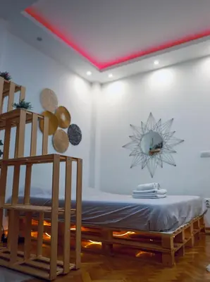 a room with a table and a clock on the wall at Boho-Style Apartment in the city center in Belgrade