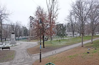 a park with a street light next to a road at Safari Downtown Apartment in Belgrade