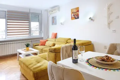 a living room with a couch and a table at Safari Downtown Apartment in Belgrade