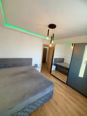 a bedroom with a large bed and a mirror at Lux apartment with a park view in Belgrade