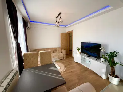 a living room with a couch and a tv at Lux apartment with a park view in Belgrade