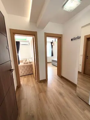 an empty room with two doors and a bedroom at Lux apartment with a park view in Belgrade