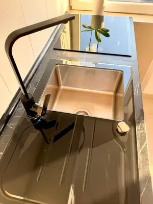 a sink with a faucet in a kitchen at Lux apartment with a park view in Belgrade