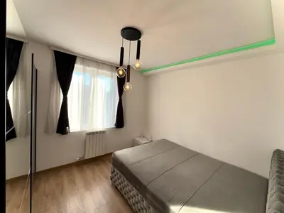 a bedroom with a bed and a window at Lux apartment with a park view in Belgrade