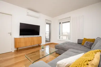 a living room with a couch and a flat screen tv at Monza in Belgrade