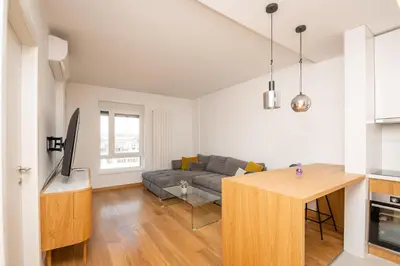 a living room with a couch and a table at Monza in Belgrade