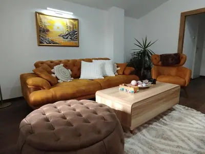 a living room with a couch and a coffee table at Kosmaj Apartmani Košutica - Marija i Ksenija in Koraćica