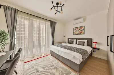 a bedroom with a bed and a large window at ZIGZAG Belgrade Waterfront - SIMFONIJA 1 in Belgrade