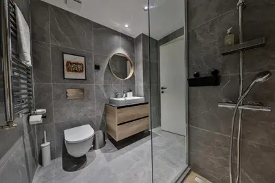 a bathroom with a shower and a toilet and a sink at ZIGZAG Belgrade Waterfront - SIMFONIJA 1 in Belgrade