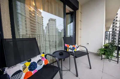 a balcony with two chairs and a table on a balcony at ZIGZAG Belgrade Waterfront - SIMFONIJA 1 in Belgrade