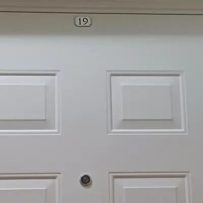 a white door with the number on it at Lola 2 in Belgrade