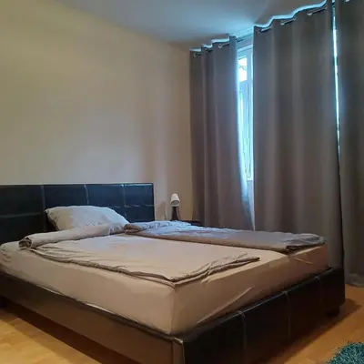 a bed sitting in a bedroom with a window at Lola 2 in Belgrade