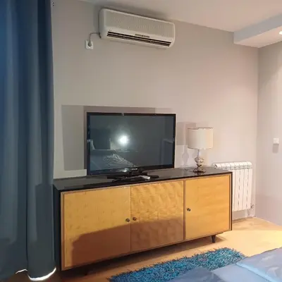 a living room with a flat screen tv on a dresser at Lola 2 in Belgrade