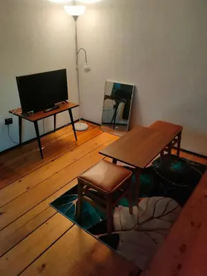 a living room with a table and a television at Industrija in Belgrade